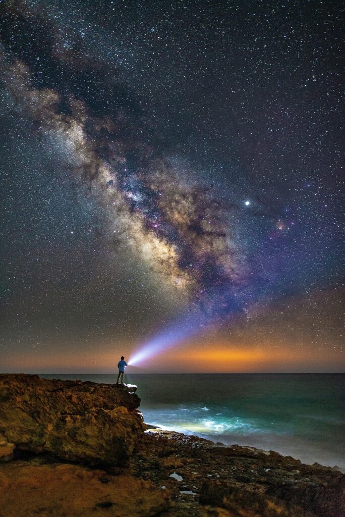 milky way, human, starry sky, star, night sky, coast, atmosphere, sky, mystical, nature, light, ray of light, lamp, flashlight